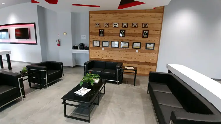 The Royal Roofing lobby in Pasco, with its wall of framed certificates and awards