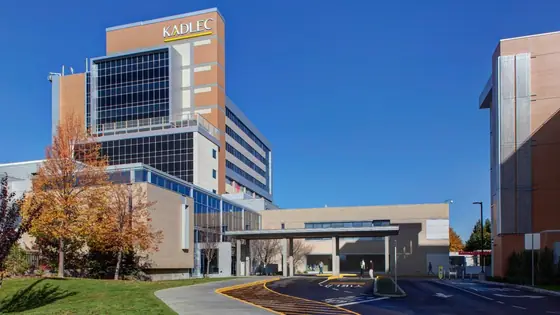 A hospital tower beside a low pavilion building