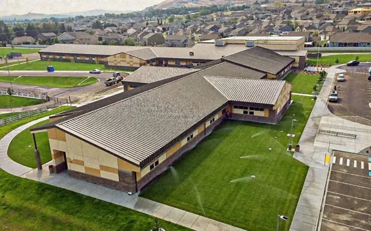 Aerial view of a school campus with standing-seam metal roofs